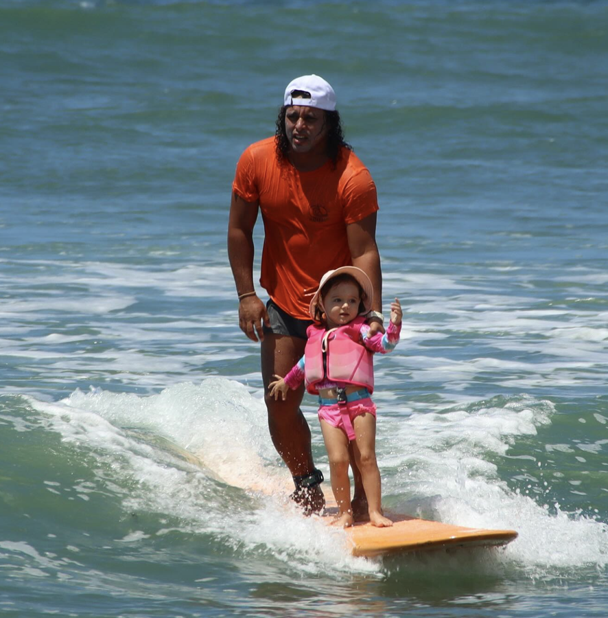 Instructor surfing with a young child