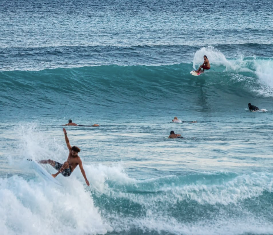 Surfers riding waves at Cabo Matapalo